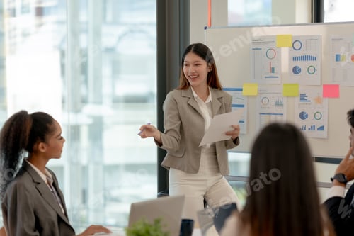 Preview: Creative young Asian businesspeople meeting to exchange ideas