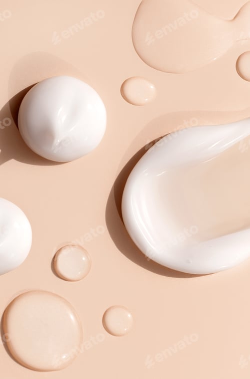 Preview: brush strokes of creamy texture of cosmetic samples on a pastel beige background