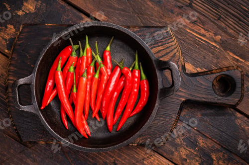 Preview: Freah Red chili peppers in a skillet isolated on white background. top view