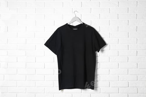 Preview: Hanger with black t-shirt against brick wall. Mockup for design