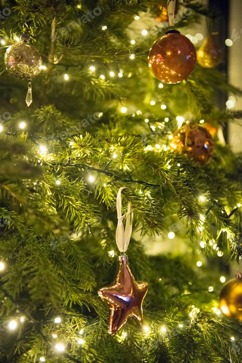 Preview: Christmas decorations. A traditional real Christmas tree, decorated with lights.