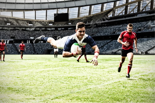 Preview: Digital composite image of rugby player jumping with the ball in sports stadium