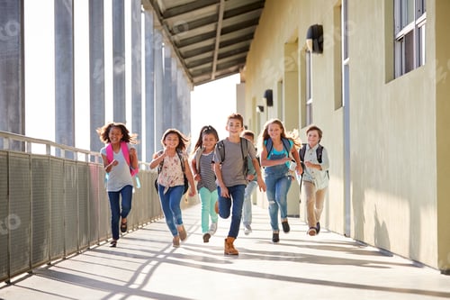 Preview: Group of elementary school kids running in a school corridor