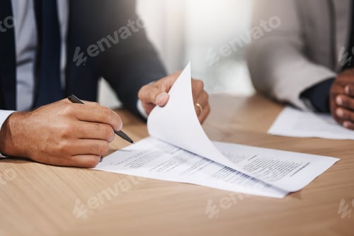 Preview: Closeup shot of two unrecognizable businesspeople going through paperwork in an office