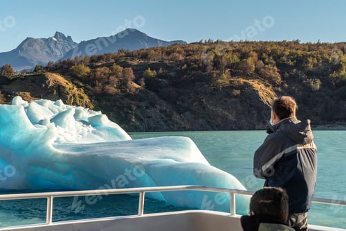 Preview: Excursion tourists watching the iceberg from the boat.
