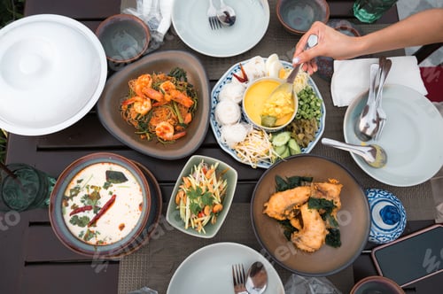 Preview: Top view of Thai food with salted crab, rice noodles, fried sea bass, sliced mango spicy, chicken