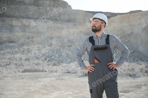 Preview: Worker in hardhat standing in stone quarry