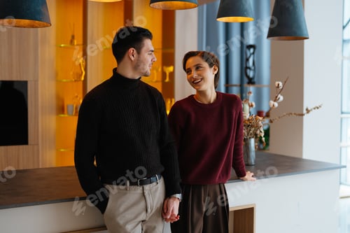 Preview: Couple sharing a joyful moment in a modern interior setting