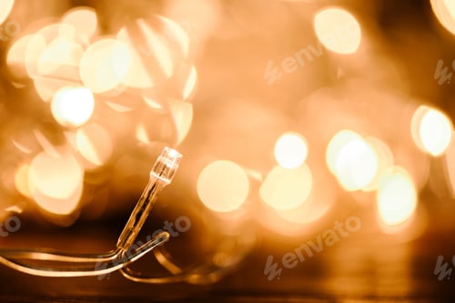 Preview: close up view of festive garland and bokeh lights backdrop