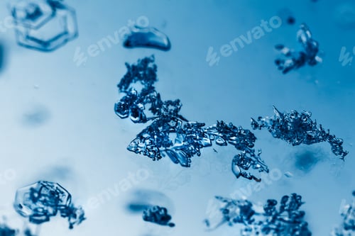 Preview: Closeup shot of melting snowflakes on a mirror surface