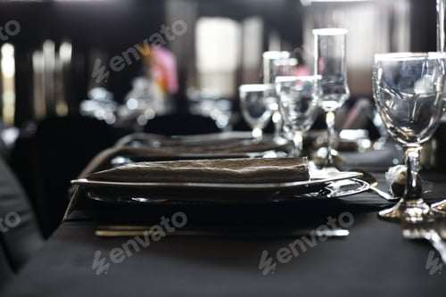 Preview: Closeup shot of cups and plates on the black table