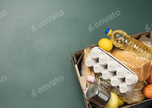 Preview: Cardboard box with various products, fruits, pasta, sunflower oil in a plastic bottle