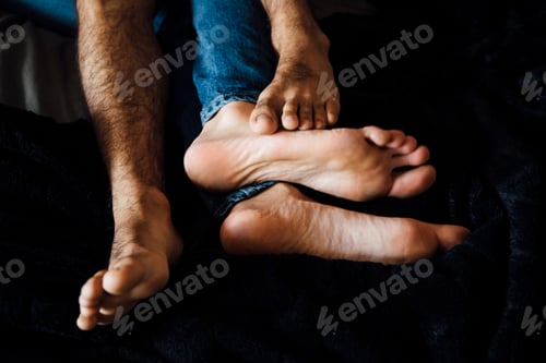 Preview: Male couple lying together, focus on feet