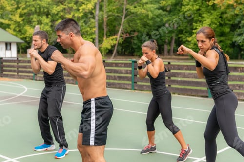 Preview: A group of individuals participating in Tae Bo training outdoors, enhancing physical fitness