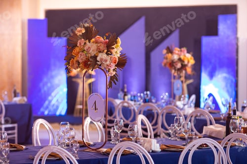 Preview: Festive table with blue cloth, napkins, plates, cutlery and glasses prepared for wedding guests
