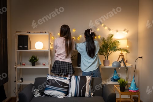 Preview: Two Asian women in room with Ciematic lighting celebrate important events such birthdays Christmas