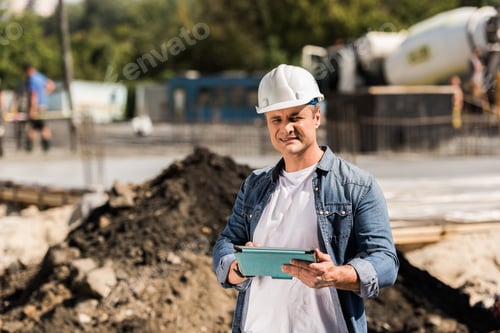Preview: handsome mature construction worker with tablet