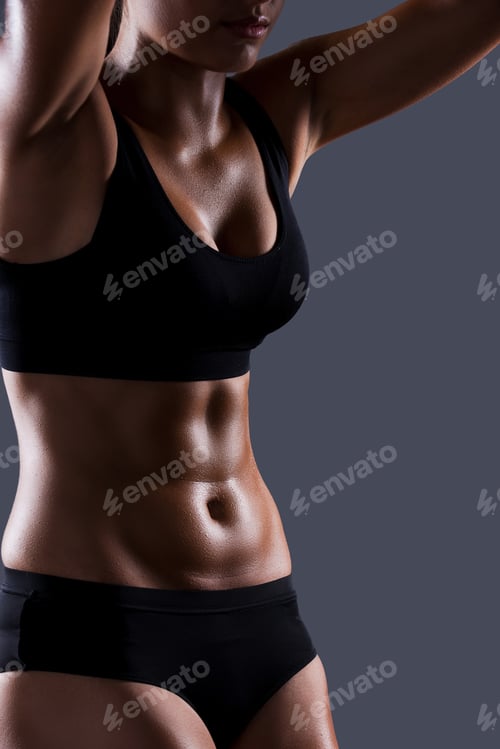 Preview: Beautiful body. Beautiful young sporty woman with perfect body posing against grey background