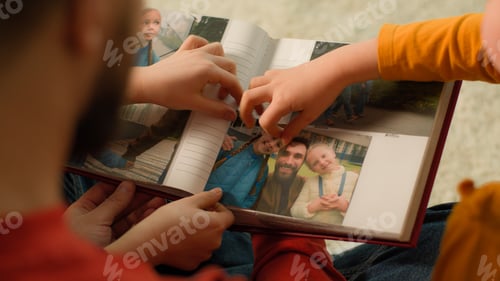 Preview: Back view Caucasian father little girls daughters school kids watching family album put photo