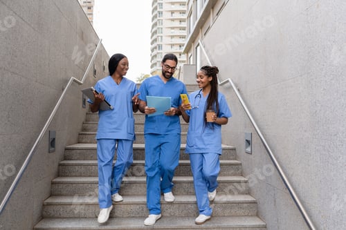 Preview: Multiracial medical students walking down hospital stairs