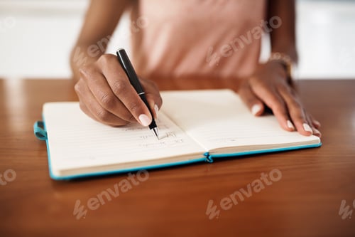 Preview: Cropped shot of a woman checking off tasks on a chore list at home