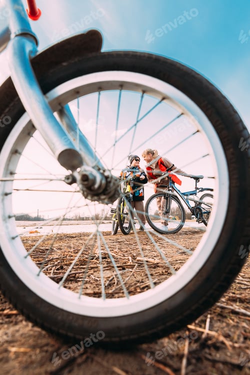Preview: Caucasian Happy Mother And Son Riding Together And Posing For Photo. View From Bicycle Wheel, Family