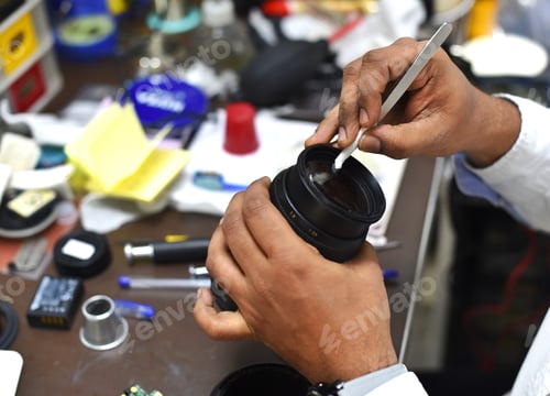 Preview: Highly trained camera technician puts finishing touches on a lens after cleaning the camera