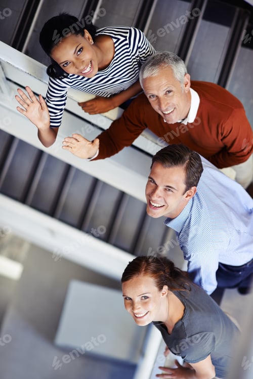 Preview: We welcome you. Shot of a group of colleagues standing on a staircase.