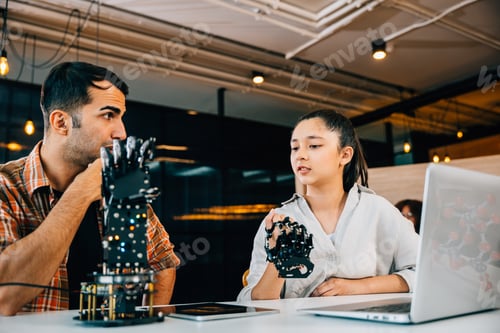 Preview: In a classroom teacher helps student build robotic arm for design and technology. Encouraging