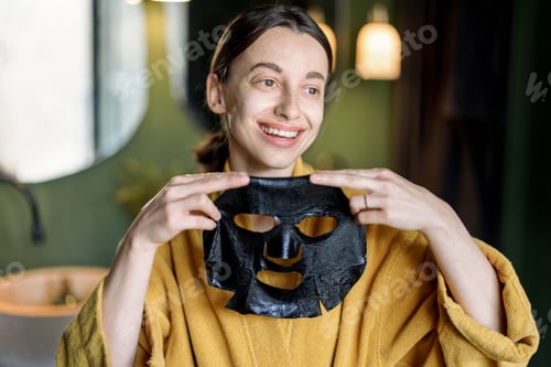 Preview: Woman applies cleansing black mask on her face