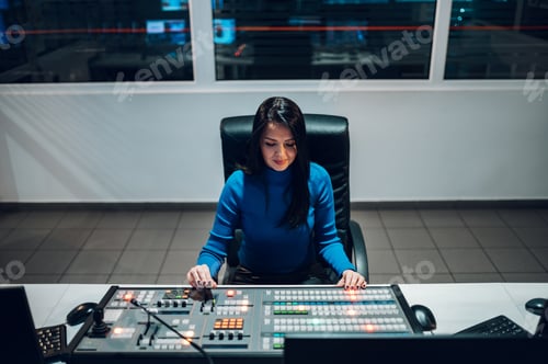 Preview: Middle aged woman using equipment in control room on a tv station