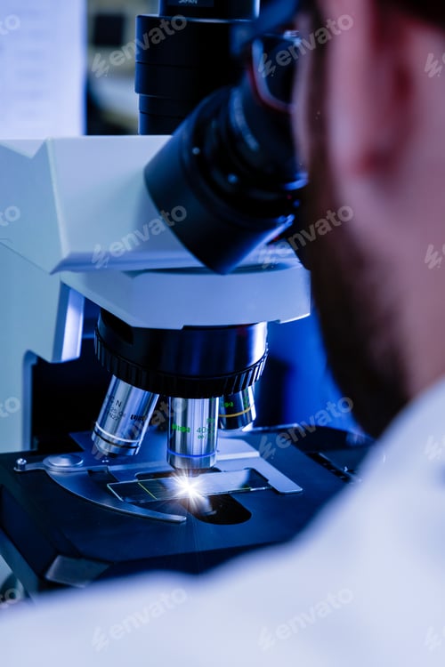 Preview: A laboratory worker working with a modern microscope while conducting a coronavirus research