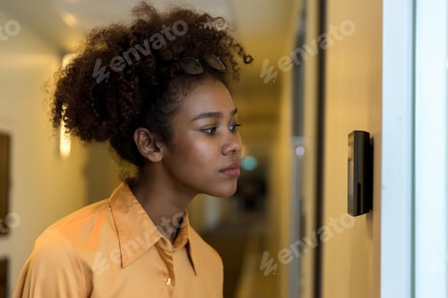 Preview: Woman using face scanner to unlock door in office building.