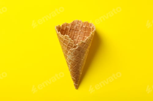 Preview: Waffle for ice cream on yellow background, space for text
