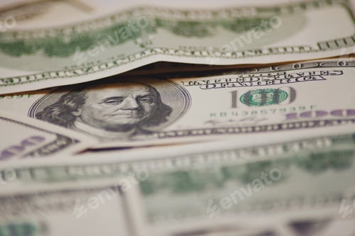 Preview: One Hundred Dollar Bills Stacked in a Pile