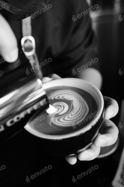 Preview: Barista making latte in coffee bar.
