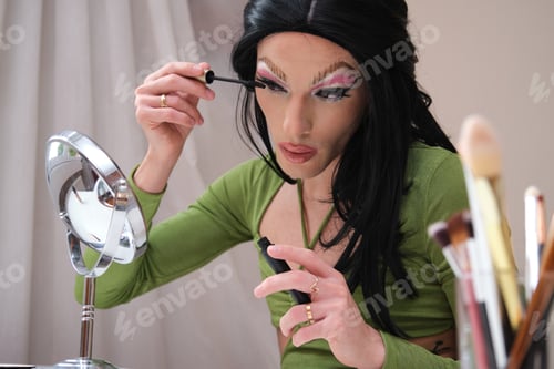 Preview: Drag queen person applying lash mascara.