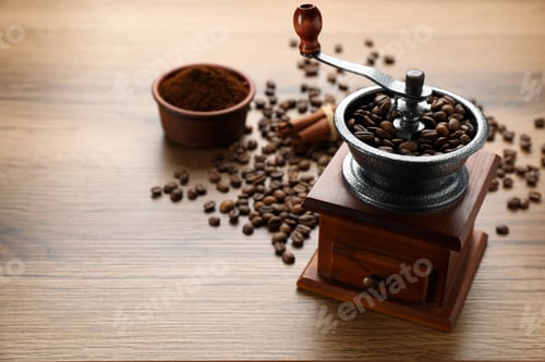Preview: Vintage manual coffee grinder with beans and powder on wooden table. Space for text