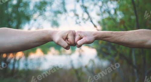 Preview: Two fists fighting men hands. Selective focus.