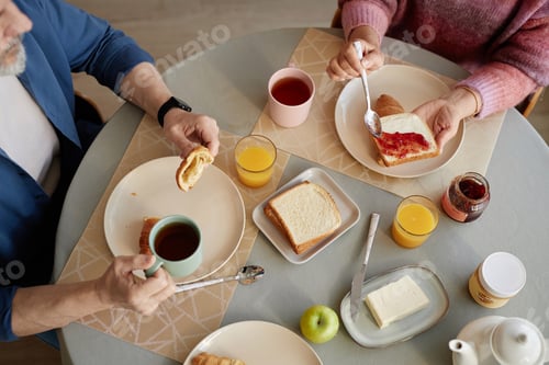 Preview: Top View Couple at Kitchen Table in Morning