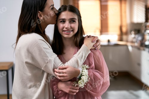 Preview: Caucasian mother kissing daughter before the prom