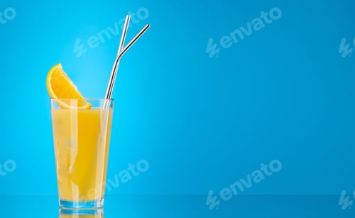 Fresh Orange Juice with Metal Straws on Blue