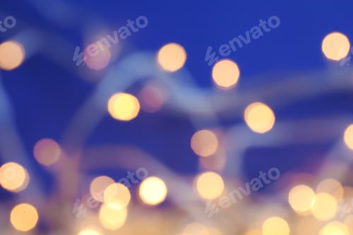 Preview: Blurred view of Christmas lights on color background