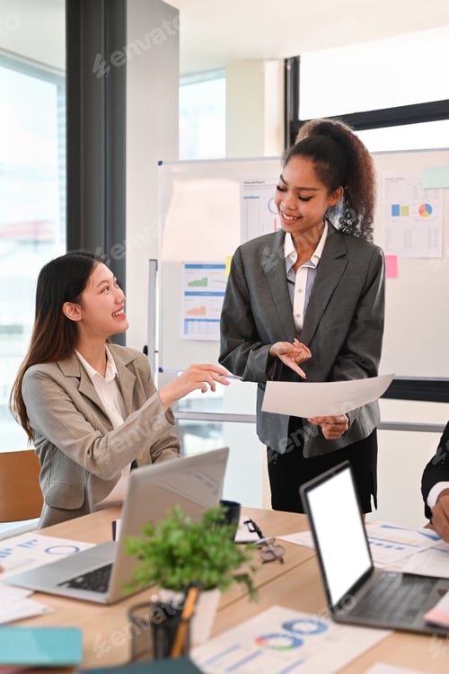 Preview: Happy young corporate colleague discussing financial graphs, working on corporate project.