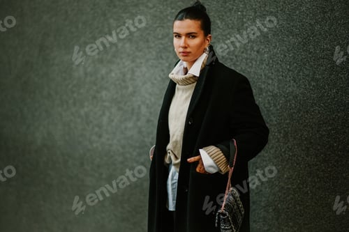 Preview: Portrait of young attractive brunette in fashionable coat on city street
