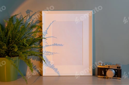 Preview: Blank frame mockup for artwork or print on green wall background.