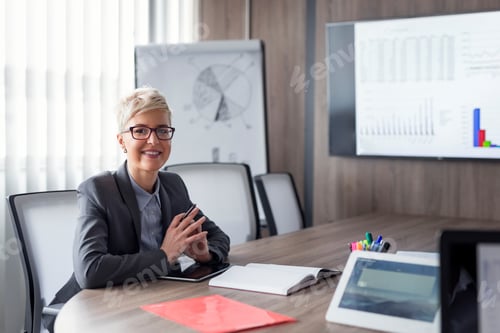 Preview: Businesswoman Smiling in Conference Room with Presentation