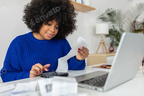 Preview: Young latin american woman managing budget and expenses bills at home.