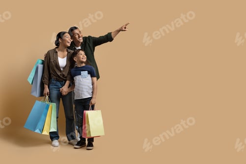 Preview: Adorable black family shopping together, looking at copy space