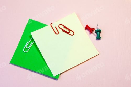 Preview: sheets of colored paper for writing are on the table , along with buttons and colored paper clips